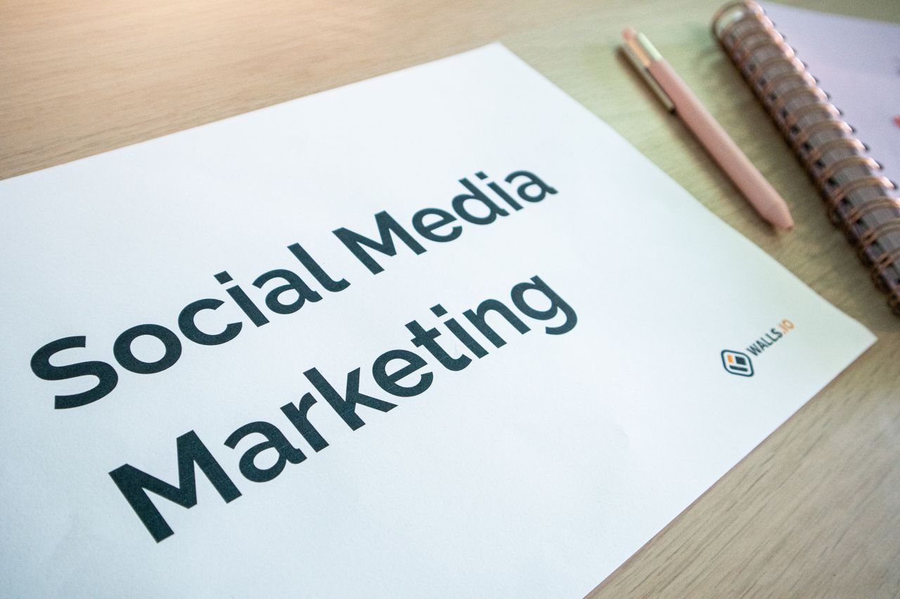 Services Close-up of a social media marketing document on a desk with a pen and notebook.