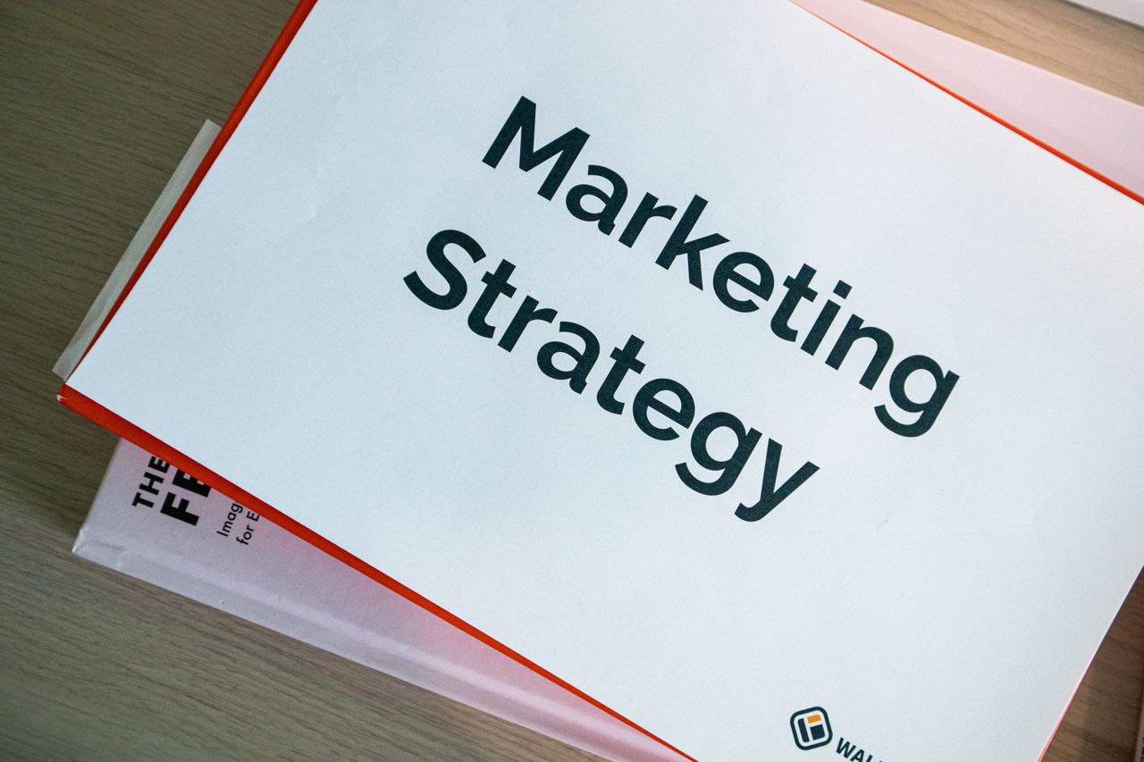 Services A marketing strategy document displayed on a desk, showcasing business planning essentials.