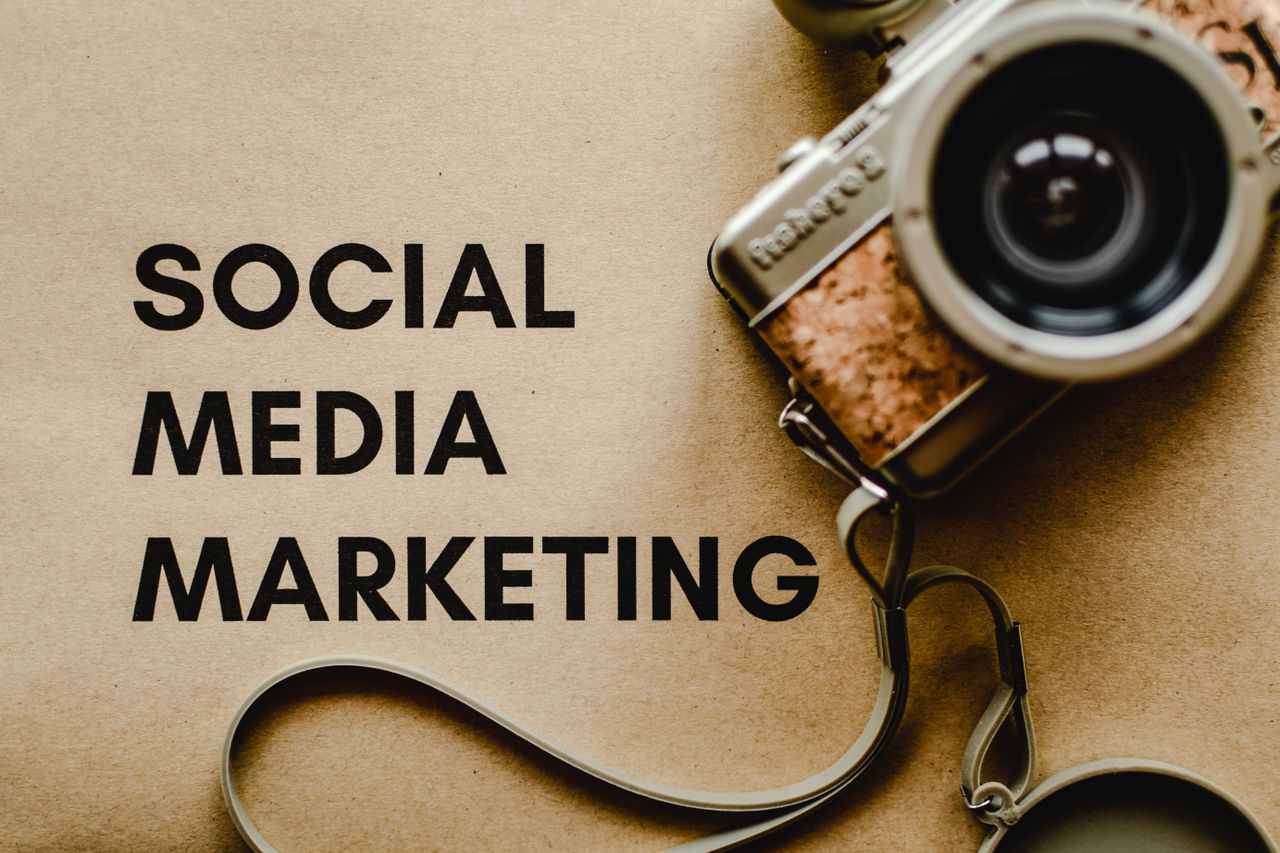 Services A vintage camera on brown paper with 'SOCIAL MEDIA MARKETING' text, perfect for marketing visuals.